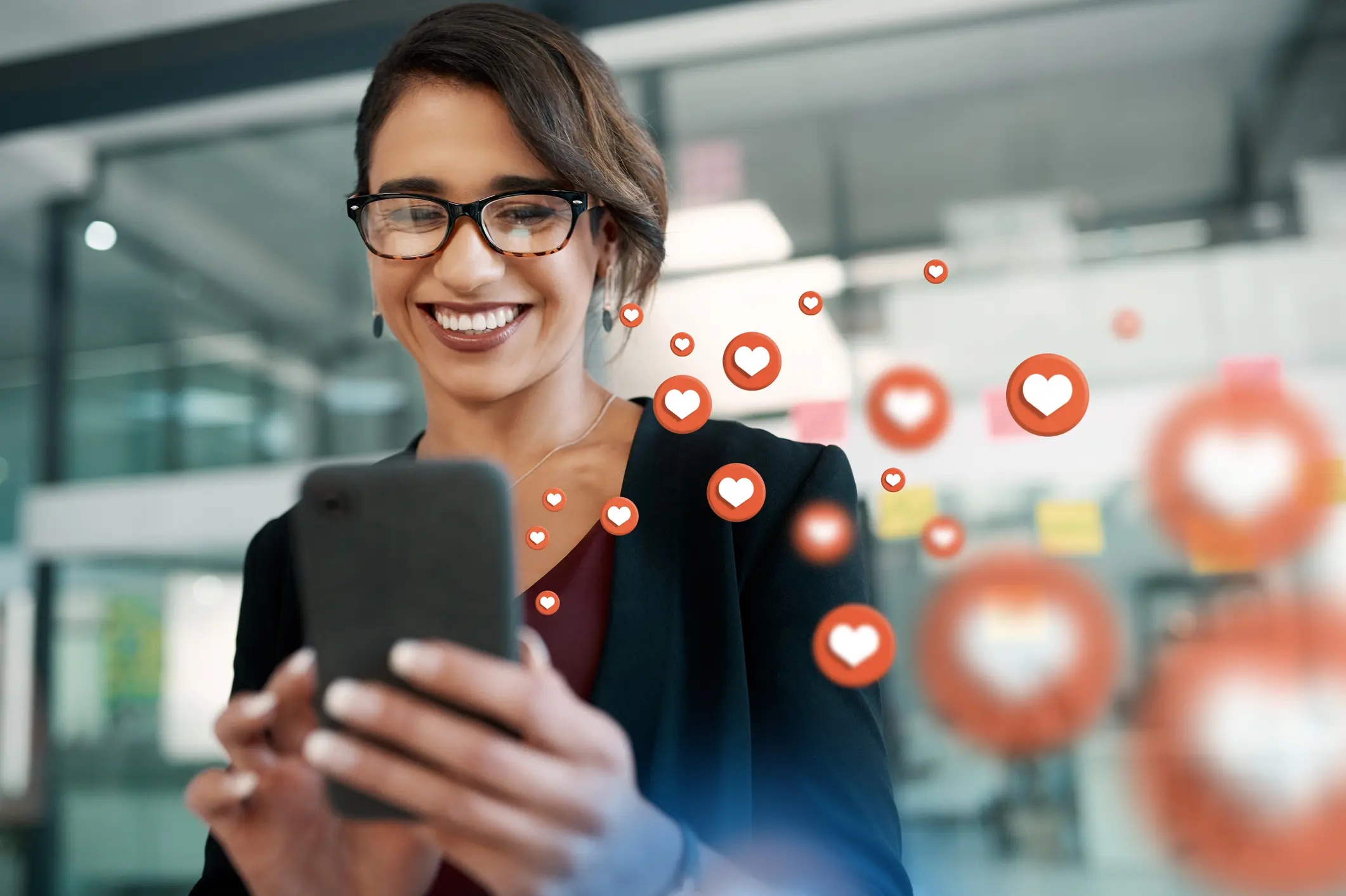 graphic overlay of a woman on mobile app website or digital network with heart emojies.