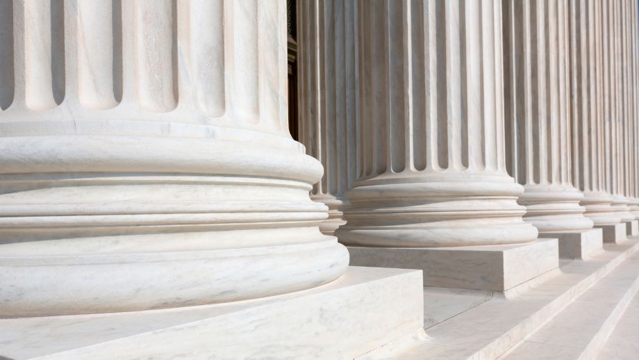 Marble columns outside of a large building.