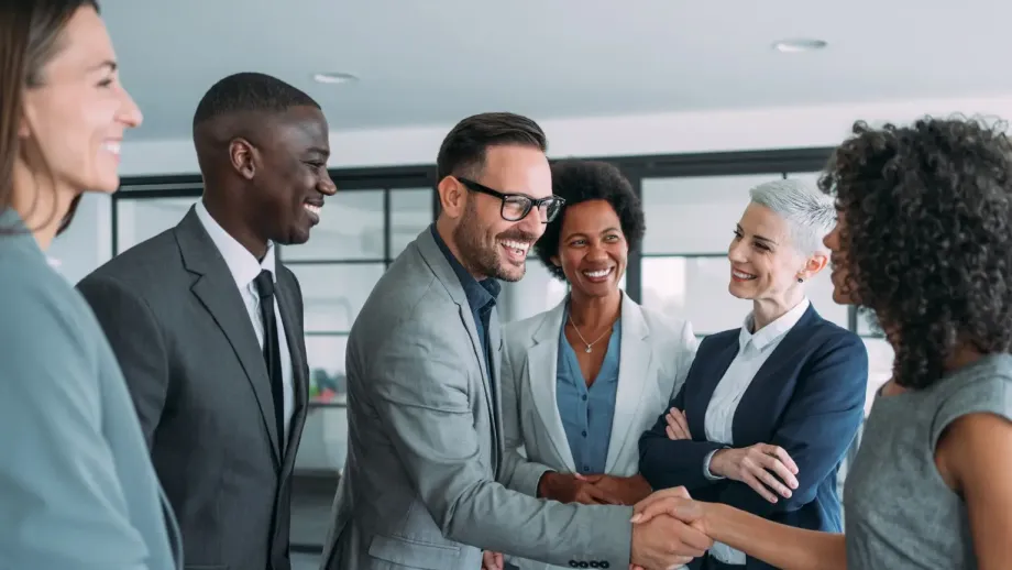 Professionals collaborating and shaking hands.