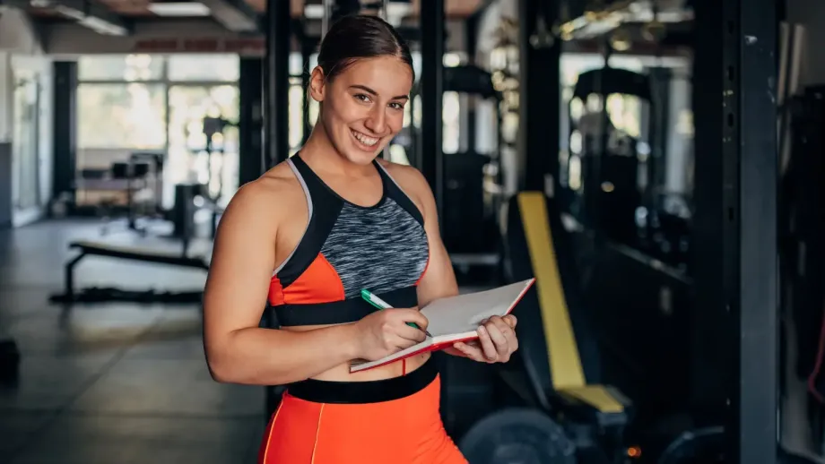 Health professional smiling and using a notebook.