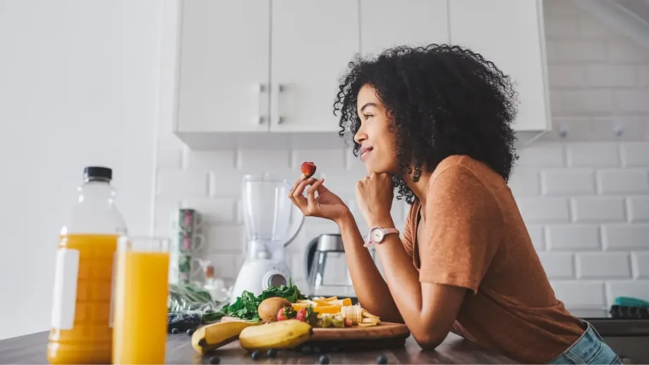 Smiling young professional eating nutritious food.