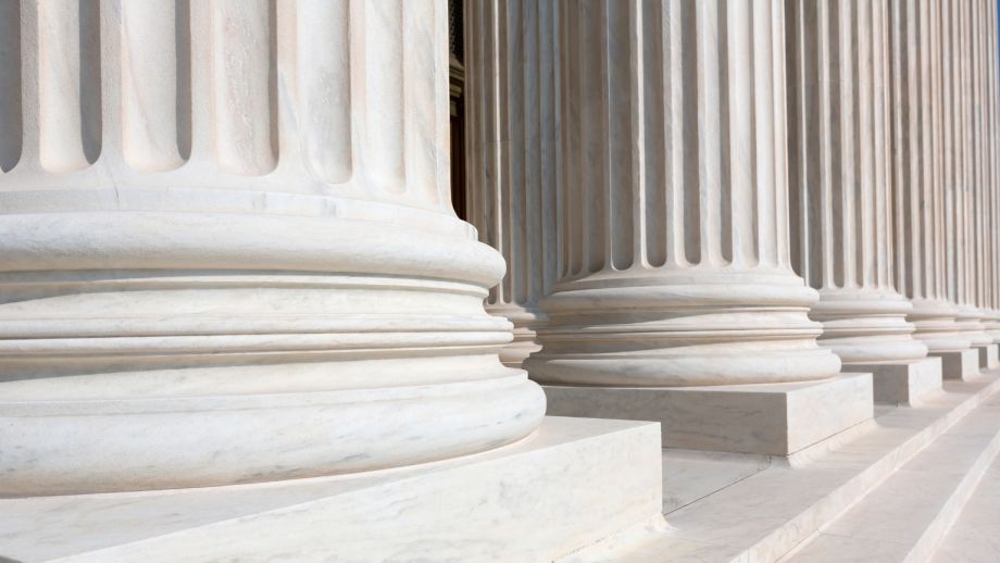 Marble columns outside of a large building.