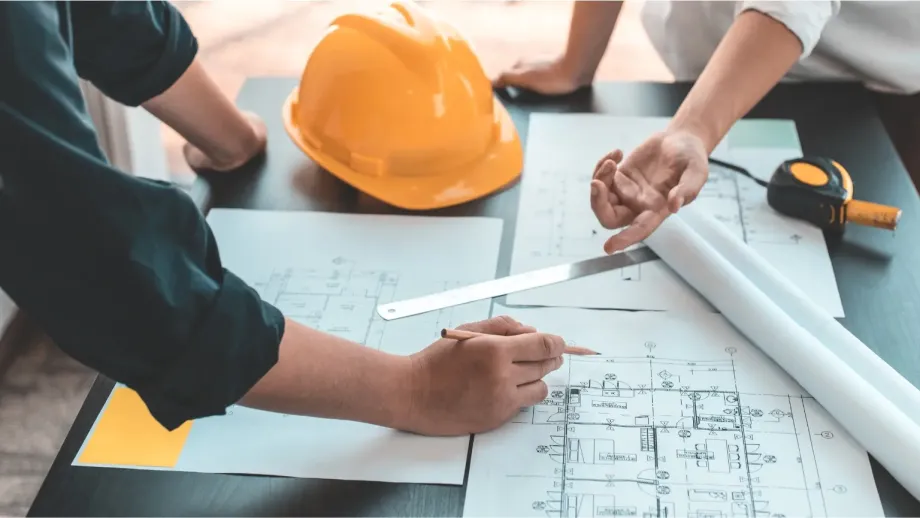 Zoomed in on blueprints and tools of engineers.