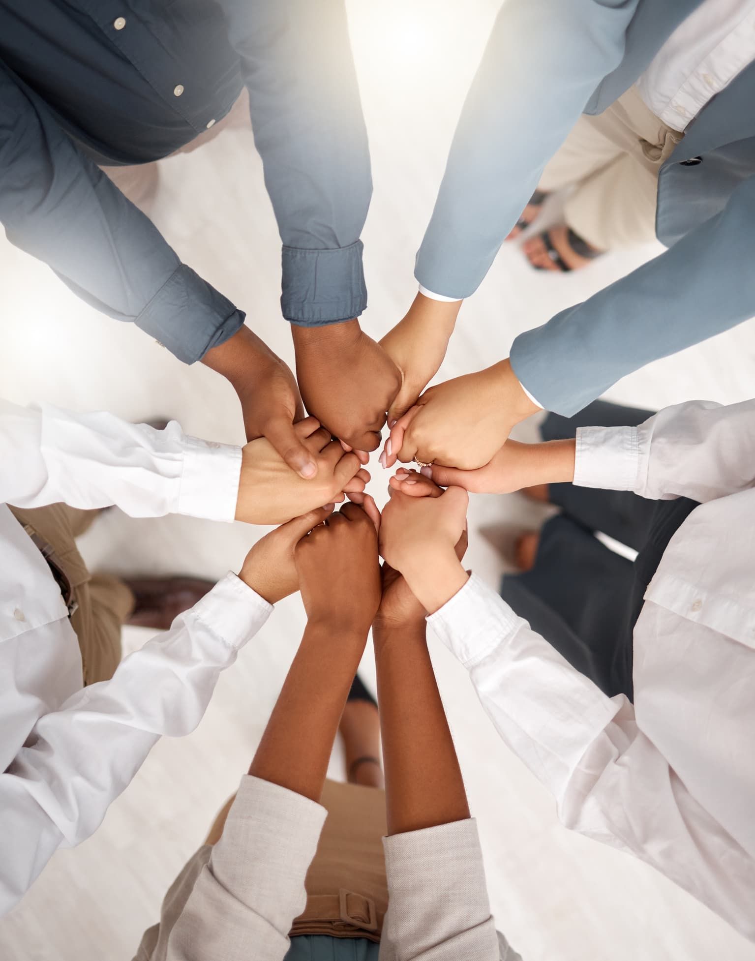 Teamwork, diversity and group holding hands in circle for support, trust and team building together.