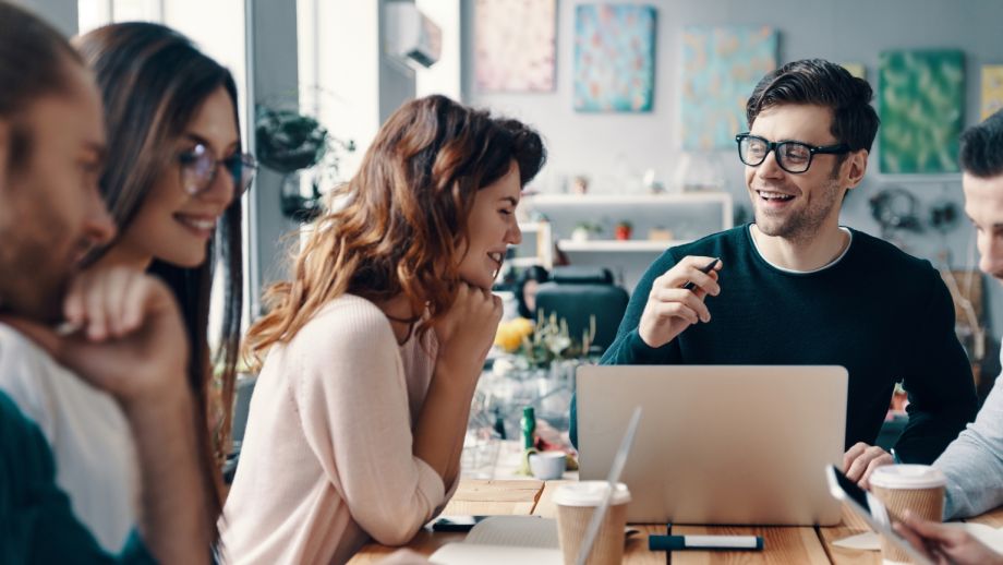 Young professionals smiling in a public setting.