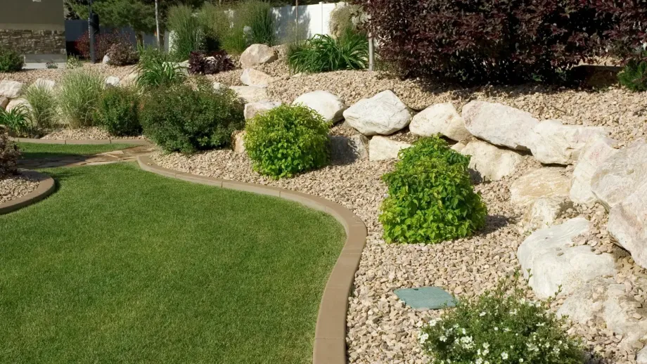 Manicured landscaping featuring grass and rocks.