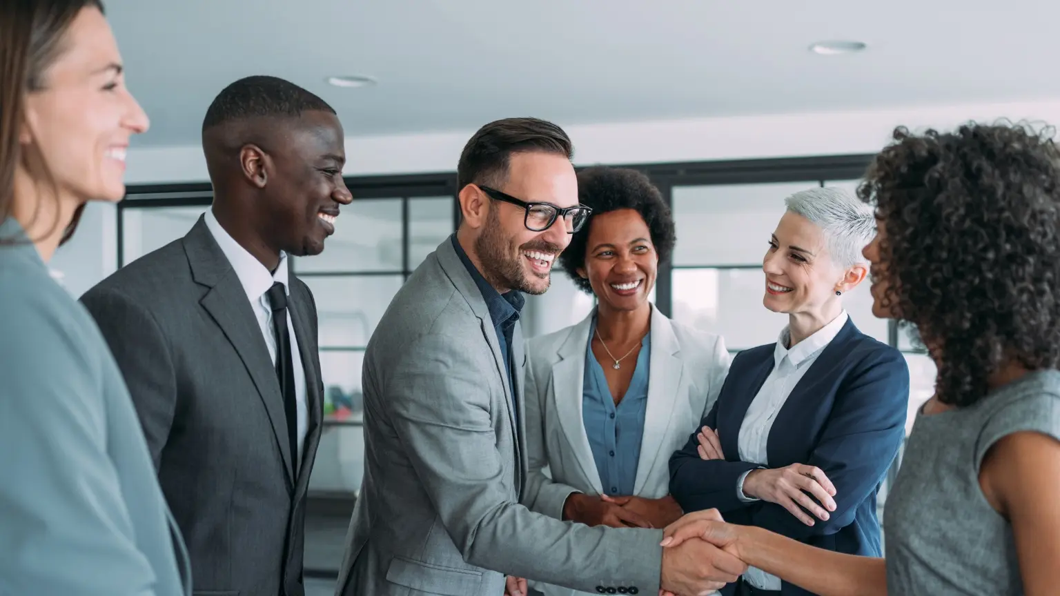 Professionals collaborating and shaking hands.